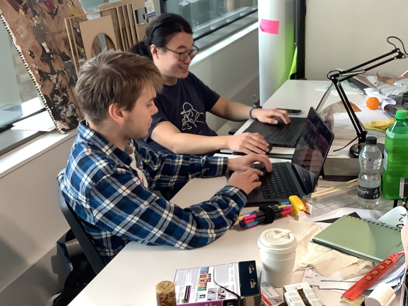 Two participants working on laptops